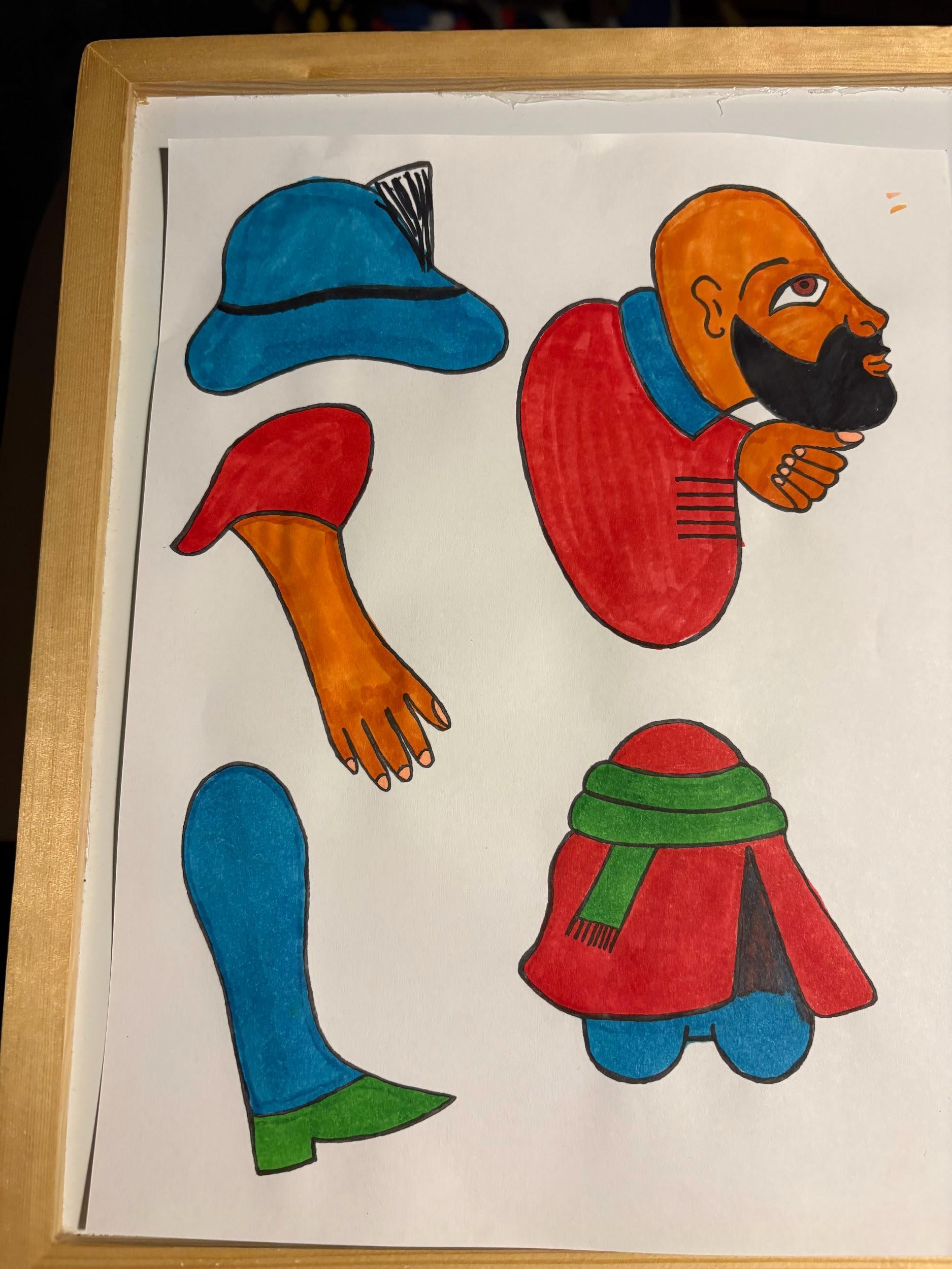 Cut and painted puppet components — heads, torsos, arms, and boots