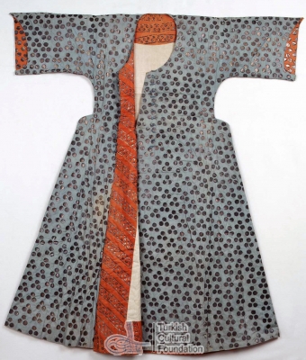 Caftan decorated with silver leaf and a contrasting orange facing